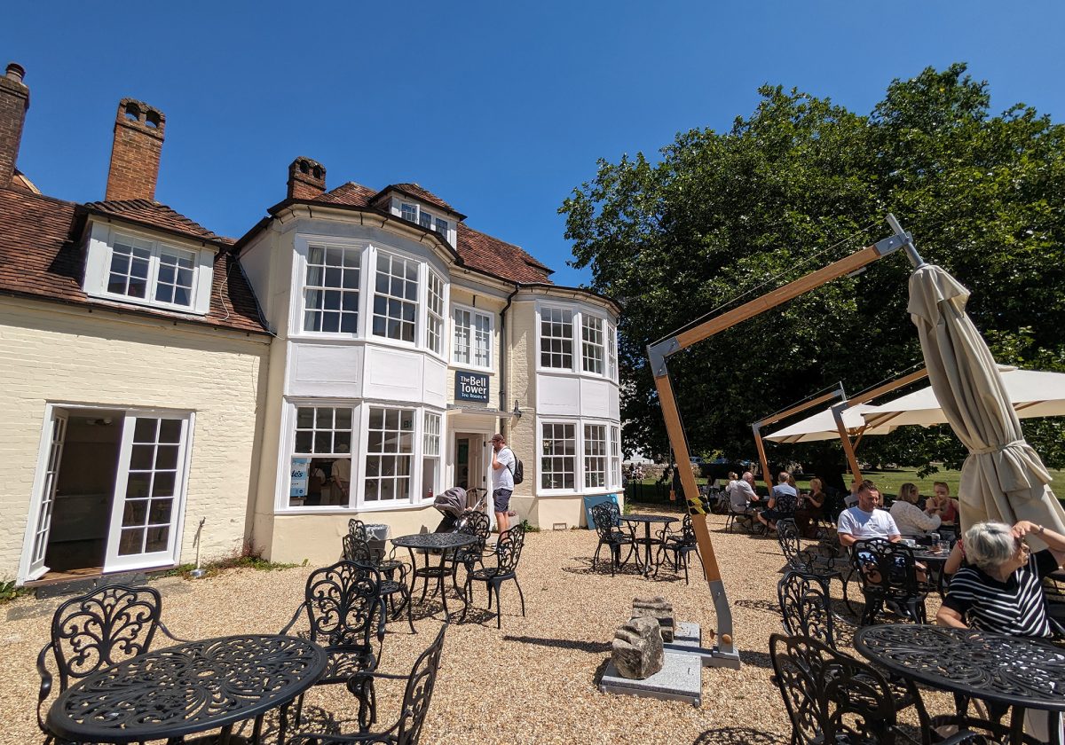 Exterior view of a building with outdoor dining tables at the front