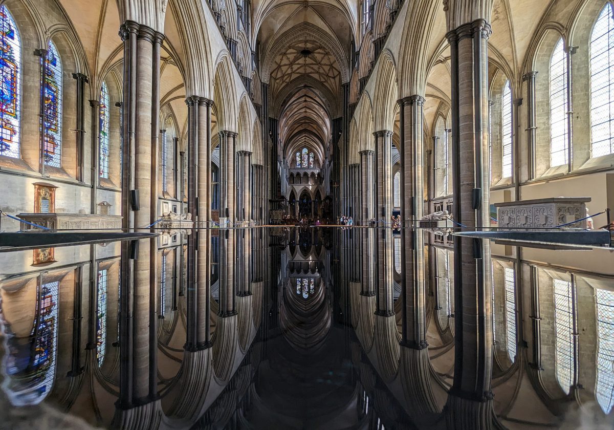 View of the inside of Salisbury Cathedral and a symmetrical reflection in the font