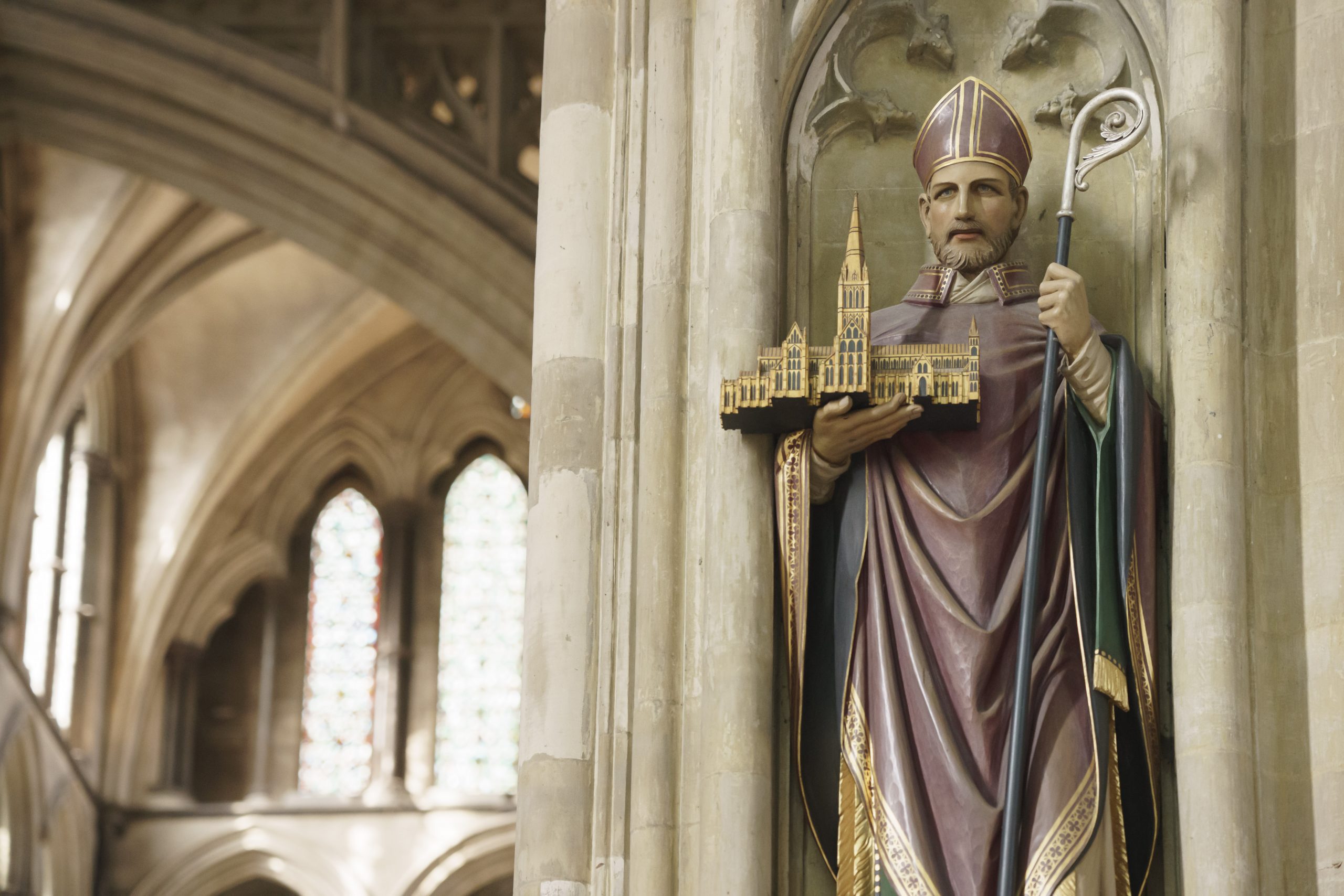 A statue of St Osmund, standing inside the Cathedral nave