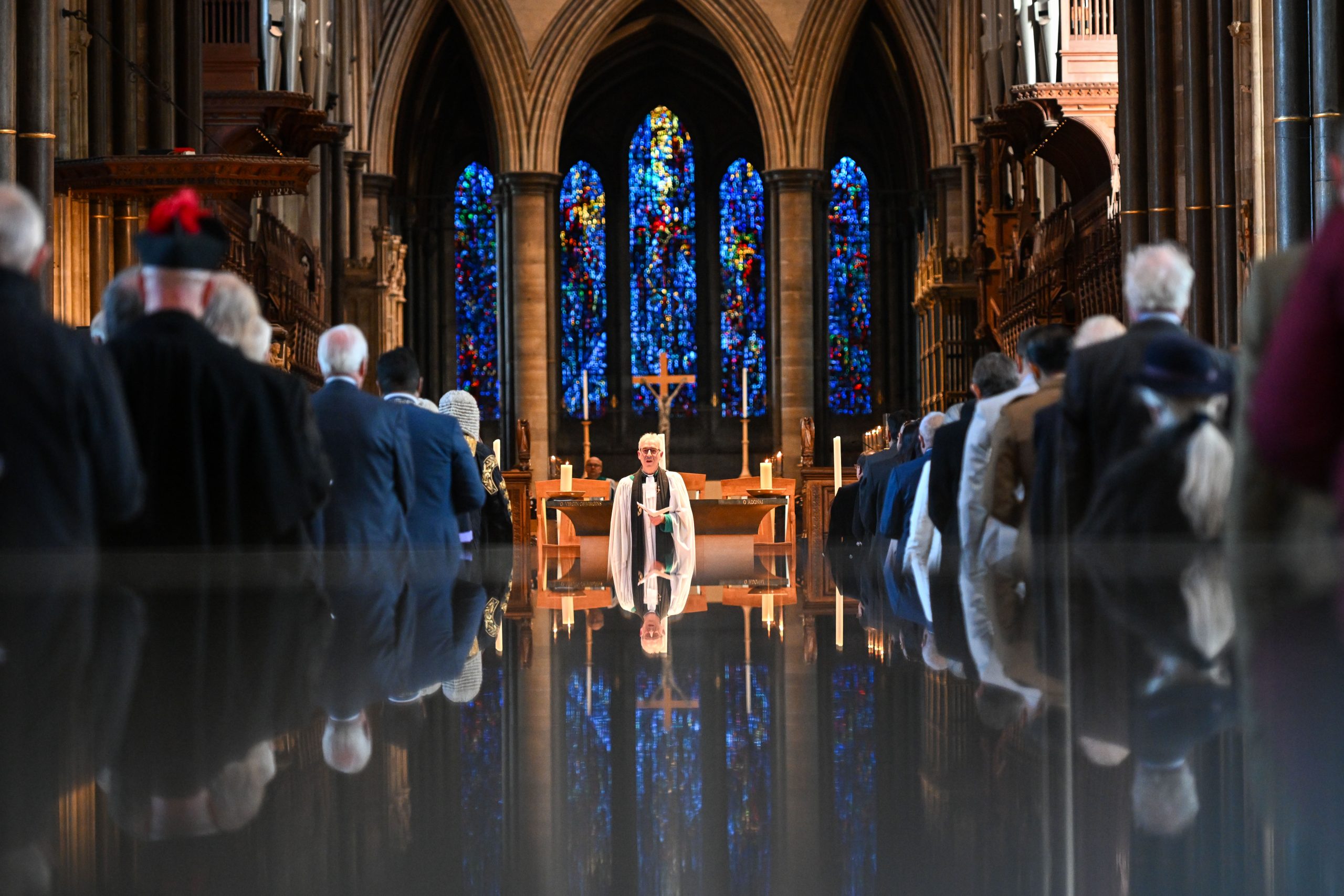 Canon Chancellor Edward Probert, reflected in the surface of the font